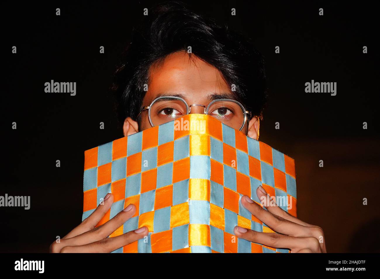 man cover face by diary and showing half face Stock Photo