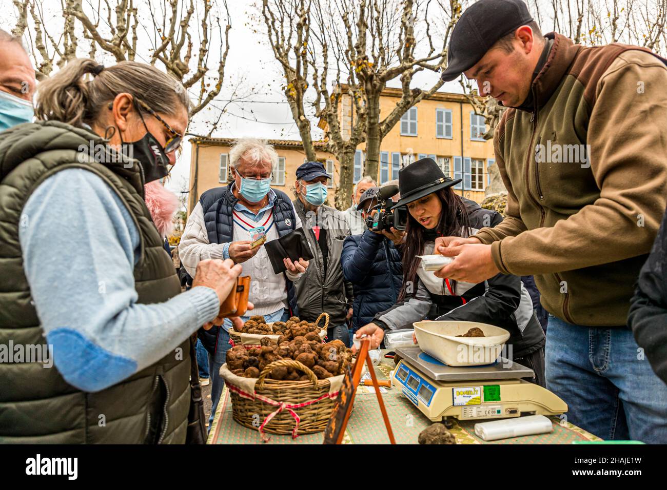 The truffle market in Aups (France) takes place every Thursday from the beginning of December until March. The truffle market of Aups is the third largest of its kind in all of France. Here the truffle dealers sell directly to end customers. Elsewhere in the truffle trade are usually interposed wholesalers. The price of the black winter truffle is about 600 euros per kilo at the beginning of the season and rises to about 1,000 euros per kilo by Christmas. Aups, France Stock Photo