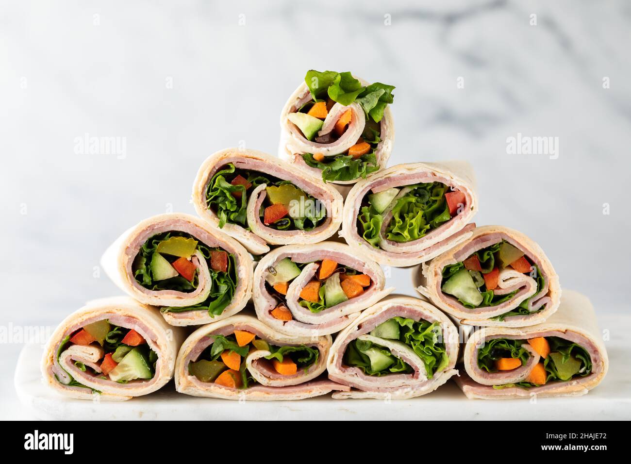 Freshly made deli wraps piled up in the shape of a pyramid Stock Photo