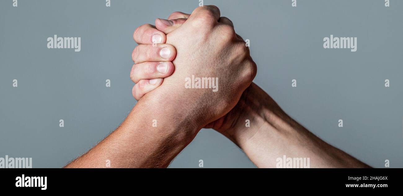 Man hand. Two men arm wrestling. Arms wrestling. Closep up. Friendly handshake, friends greeting, teamwork, friendship. Handshake, arms, friendship Stock Photo