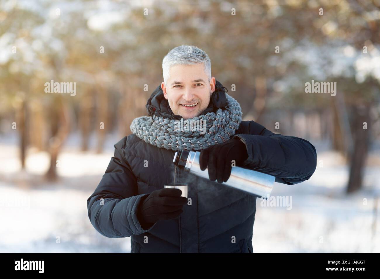 Close-up of Man Holding Thermos and an Iron Mug, Pouring Hot Tea Outdoors.  Selective Focus on Thermo Flask Stock Photo - Image of beverage, iron:  231468226