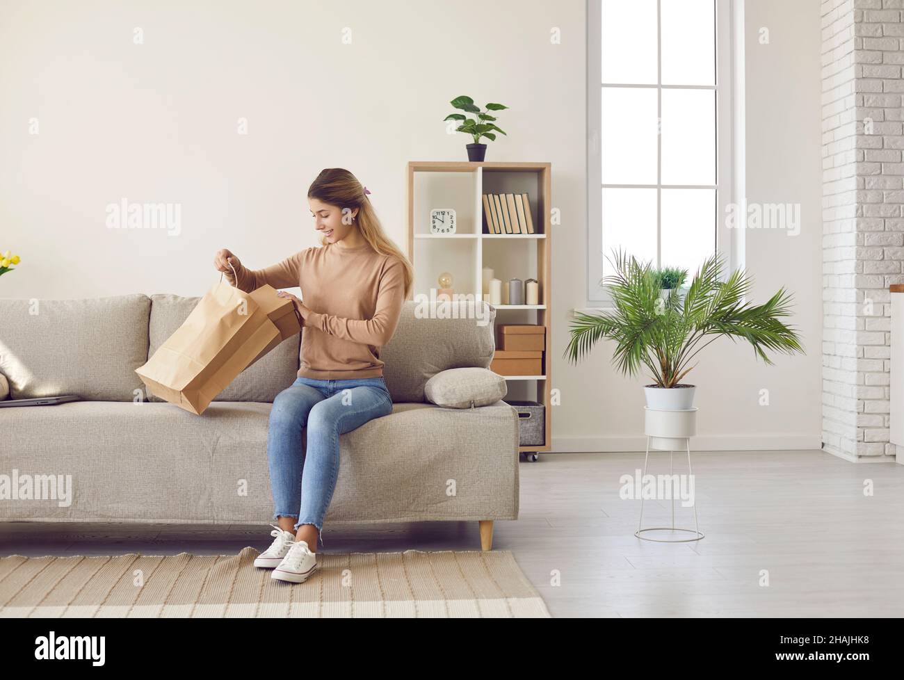 Happy woman unpack box with online order Stock Photo