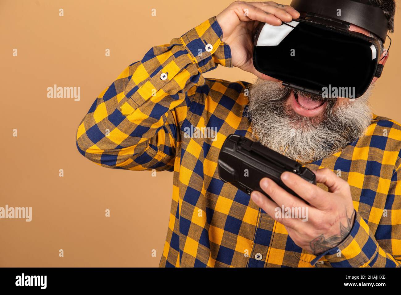 Cheerful middle-aged man with 3d glasses plays a console, virtual reality Stock Photo