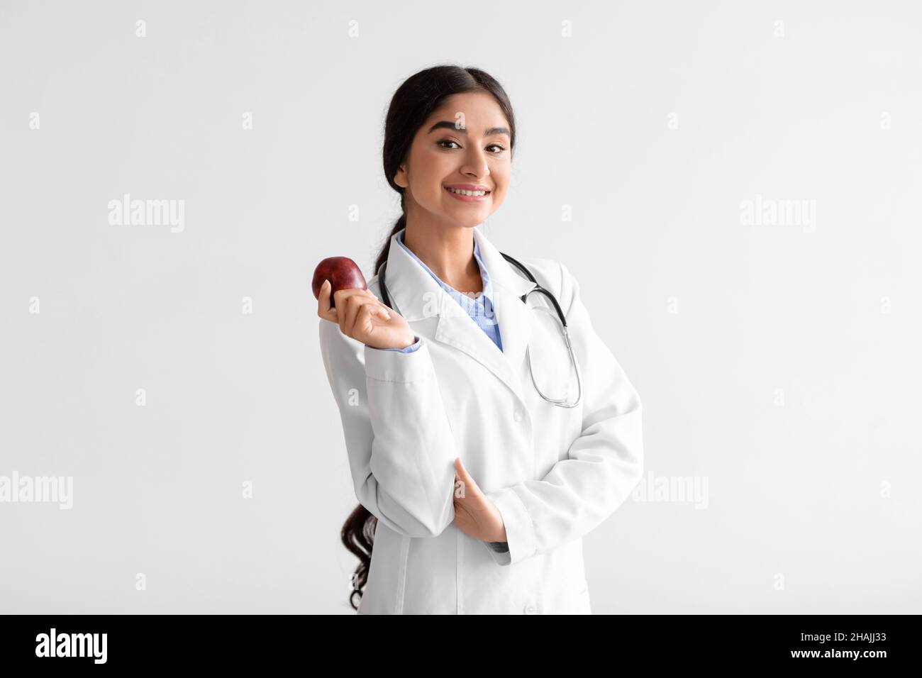 Happy pretty young indian woman doctor dentist in white coat with ...