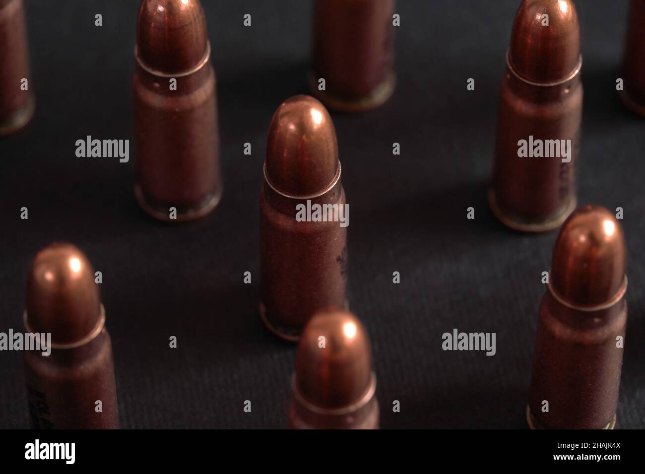Bronze pistol bullets arranged next to each other on black board, closeup detail Stock Photo Alamy