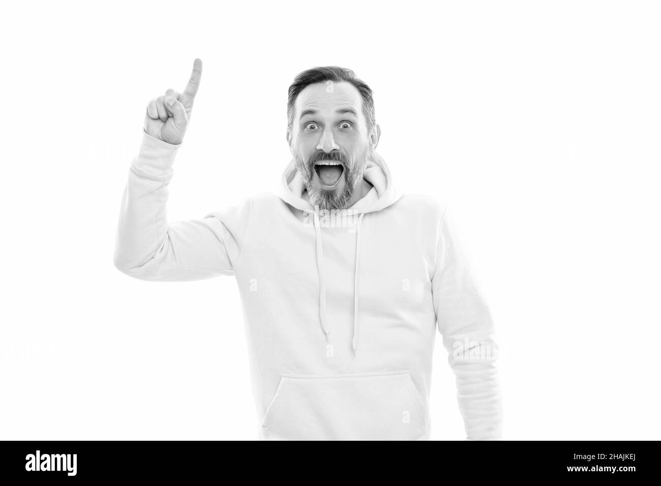 mature surprised man pointing finger up. smiling senior guy presenting product isolated on white Stock Photo