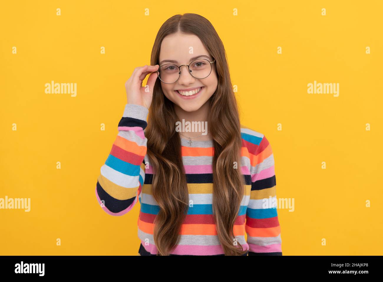 happy schoolgirl nerd child in eyeglasses for vision, vision correction Stock Photo