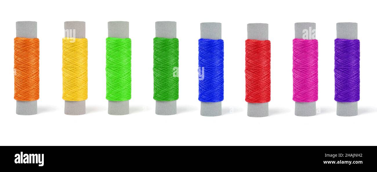 skeins of thread of different colors, set in a row on a white background Stock Photo