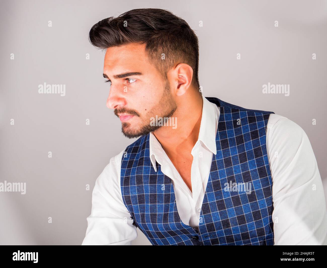 Trendy young man in studio shot wearing elegant vest Stock Photo