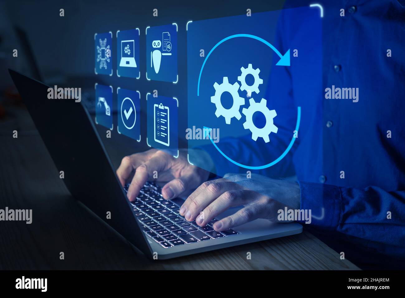 Robotic Process Automation (RPA) technology to automate business tasks with AI. Concept with expert setting up automated software on laptop computer. Stock Photo