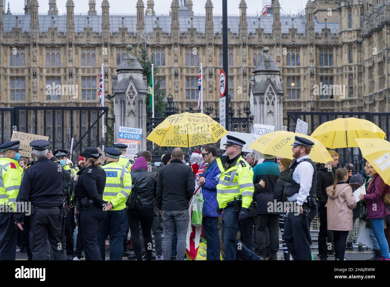 London Westminster UK.  13 December 2021. Protesters gathered outside the House of Parliament holding various messages on placard, with heavy police present keeping law and order. Credit: Xiu Bao/Alamy Live News Stock Photo