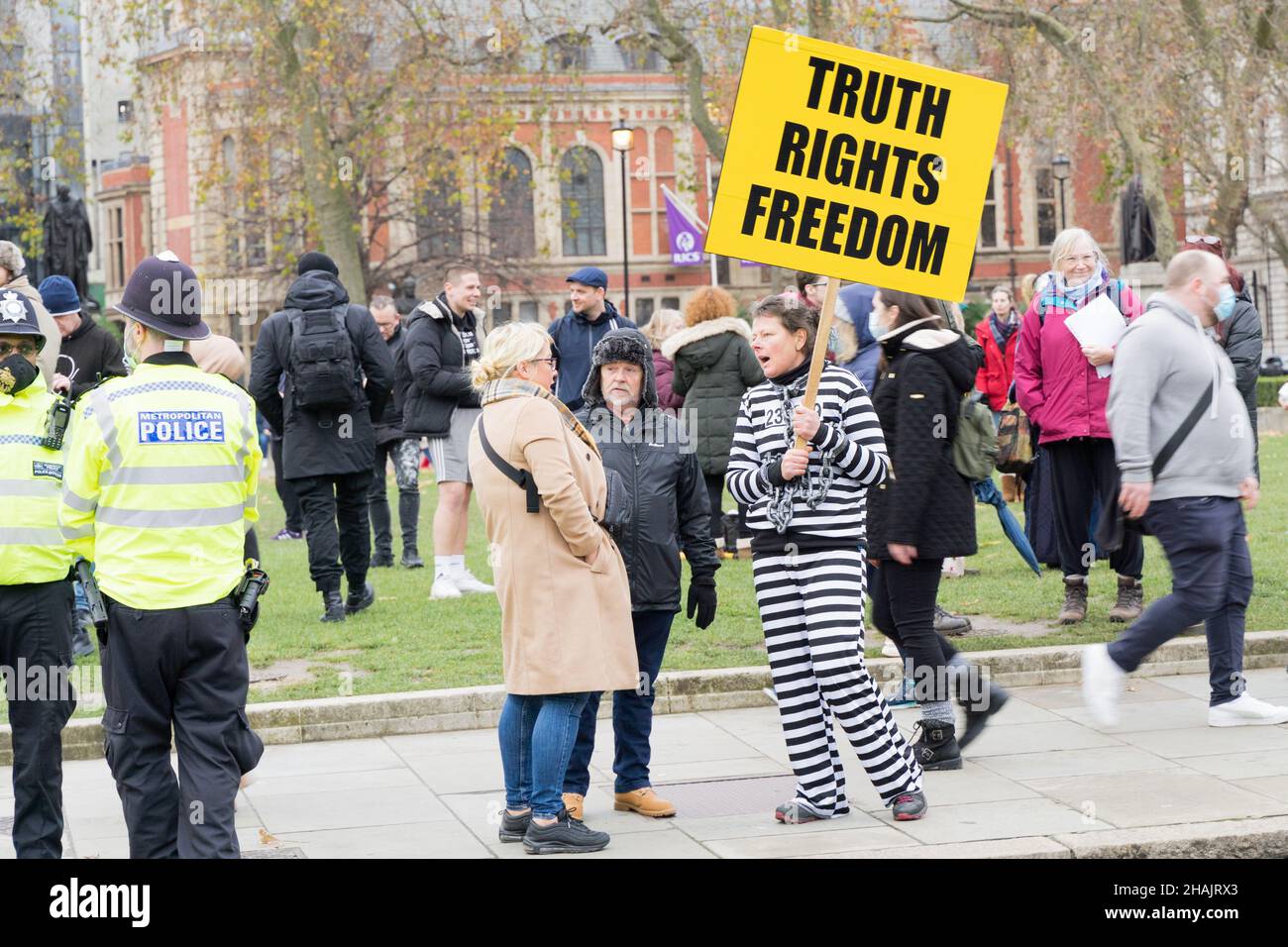 London Westminster UK.  13 December 2021. Protesters gathered outside the House of Parliament holding various messages on placard, with heavy police present keeping law and order. Credit: Xiu Bao/Alamy Live News Stock Photo