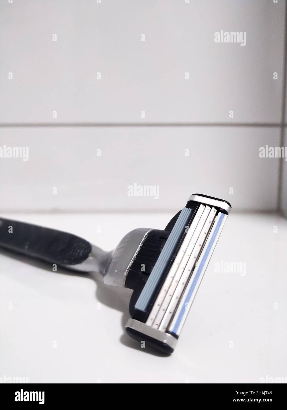Close-up shot of a razor in a bathroom Stock Photo - Alamy