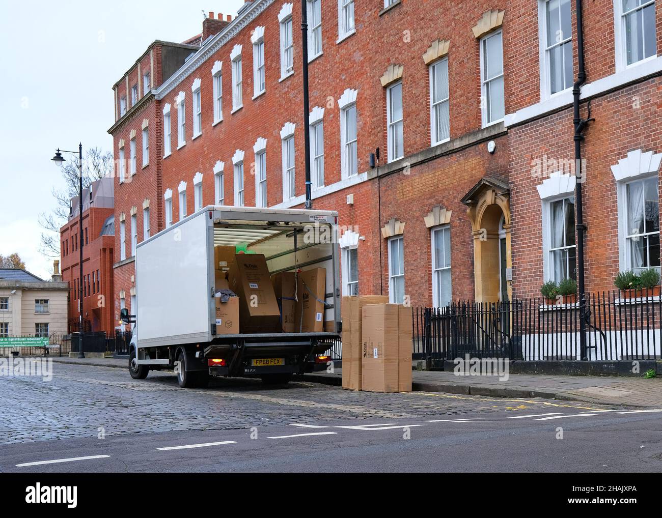 December 2021 - Medium sized van truck delivering large boxes to   an office in Brunswick Square, Bristol, England, UK., Stock Photo