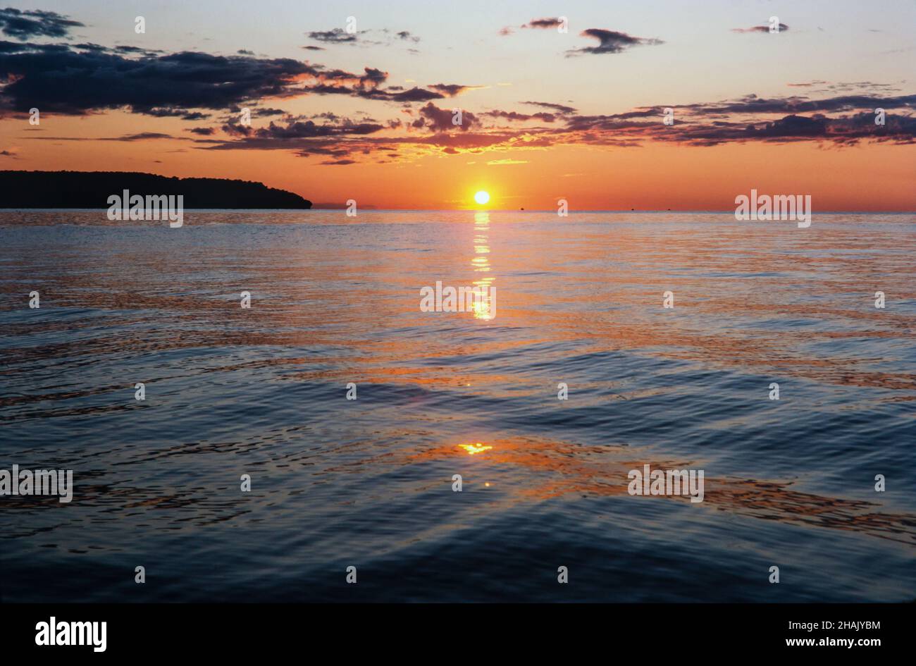 The sun sets over Lake Michigan at Gills Rock, Wisconsin, on the Door County peninsula. Stock Photo