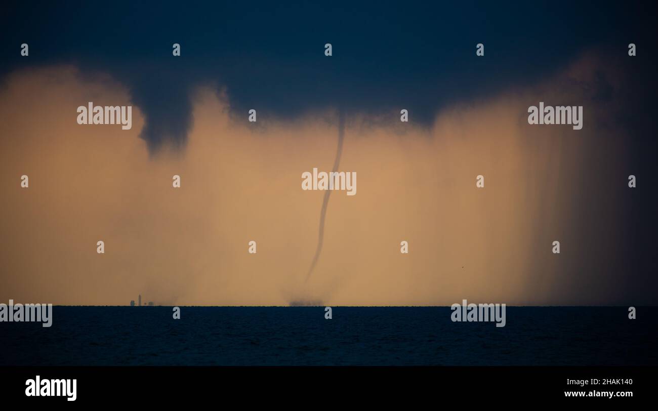 Tornado in the sea during the day against the sky Stock Photo