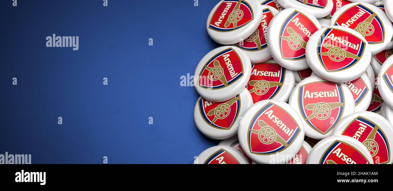 Logos of the English Soccer Club FC Arsenal on a heap on a table. Copy space. Web banner format Stock Photo