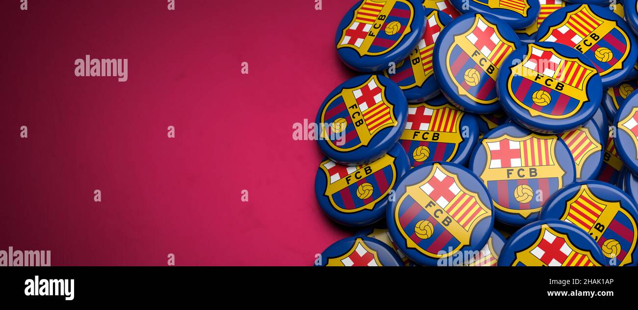 Logos of the Spanish Soccer Club FC Barcelona on a heap on a table. Copy space.  banner