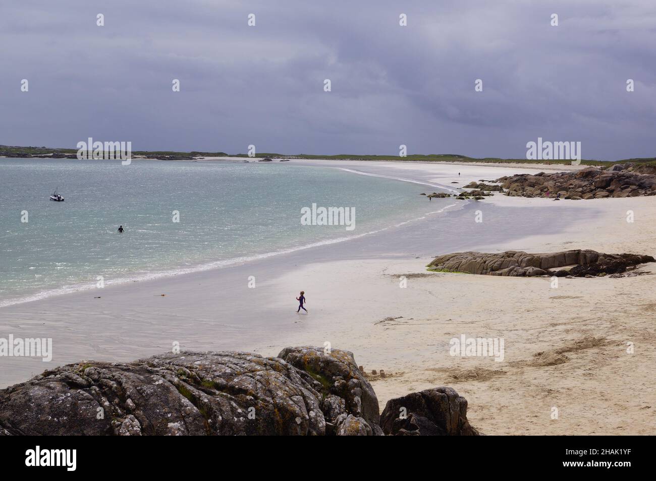 A panoramic view of Coral Strand Beach and the blue sea in Connemara