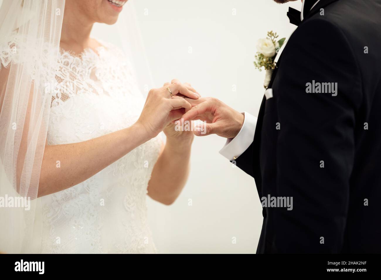 Wedding rings. Her Put the Wedding Ring on He. Close up Bride Put the