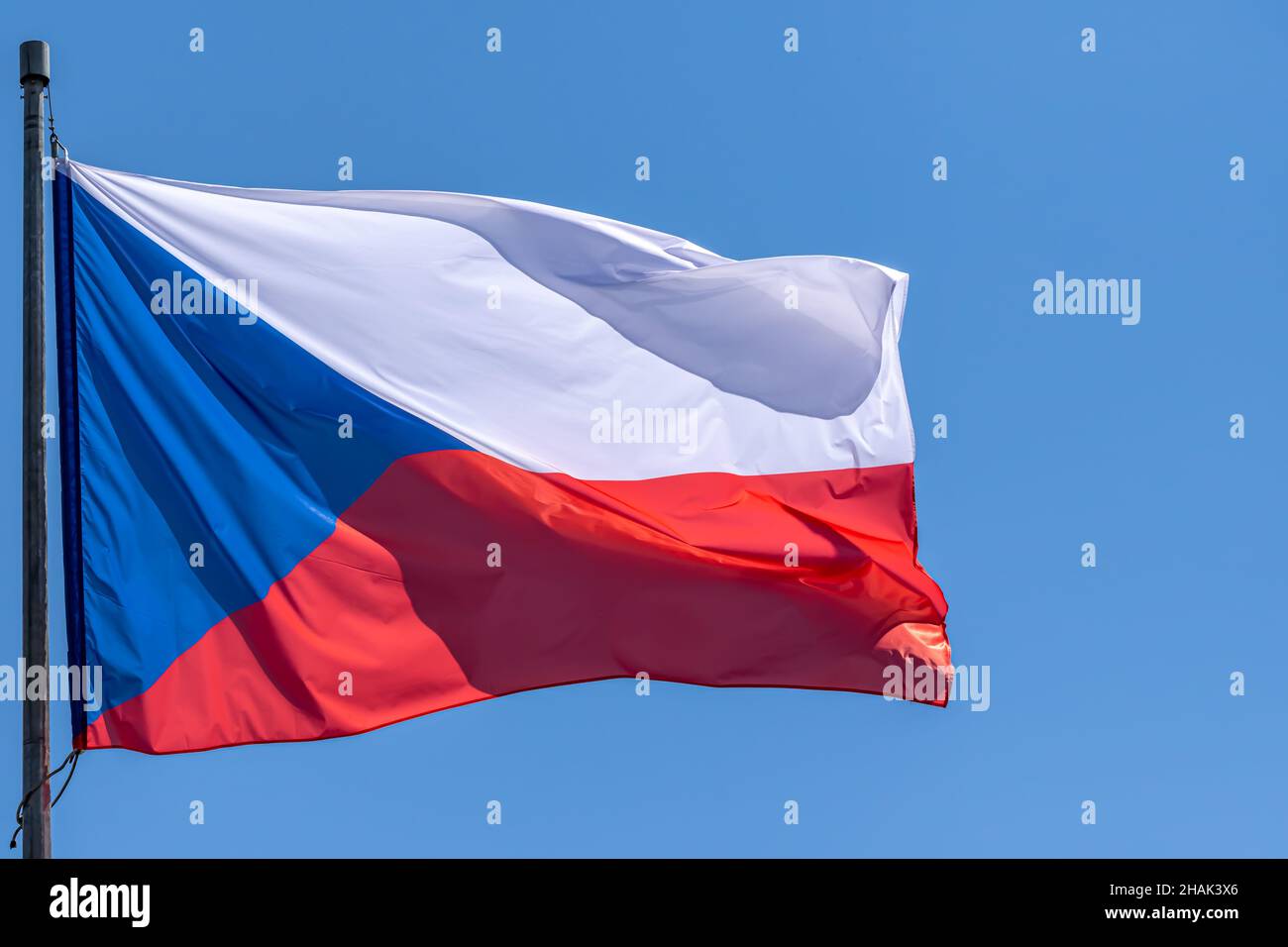 Czech national flag waving on blue sky background. Czech Republic, CZ Stock Photo