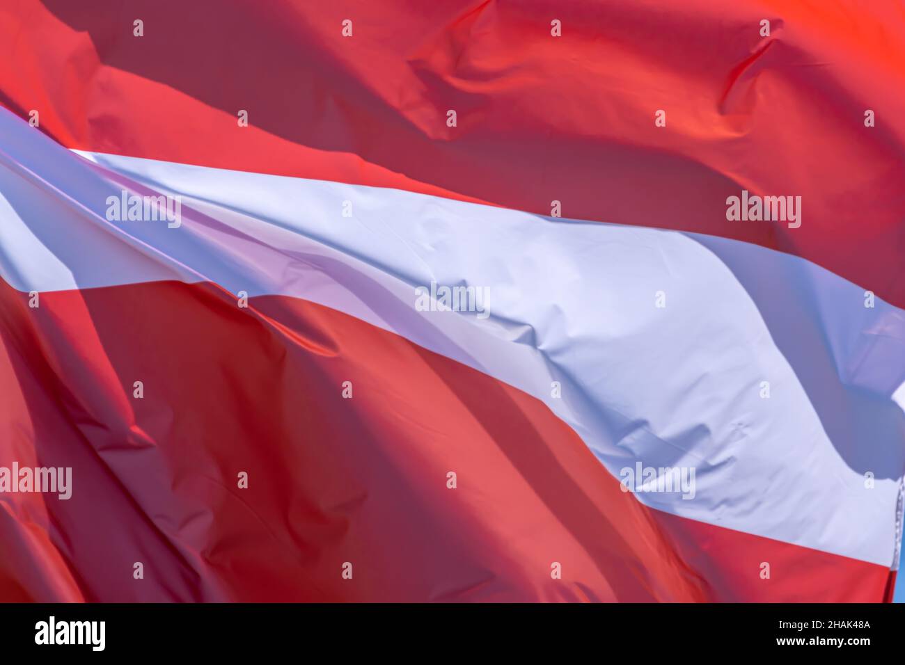 Part of Latvian national flag waving, close-up. Republic of Latvia, CY Stock Photo