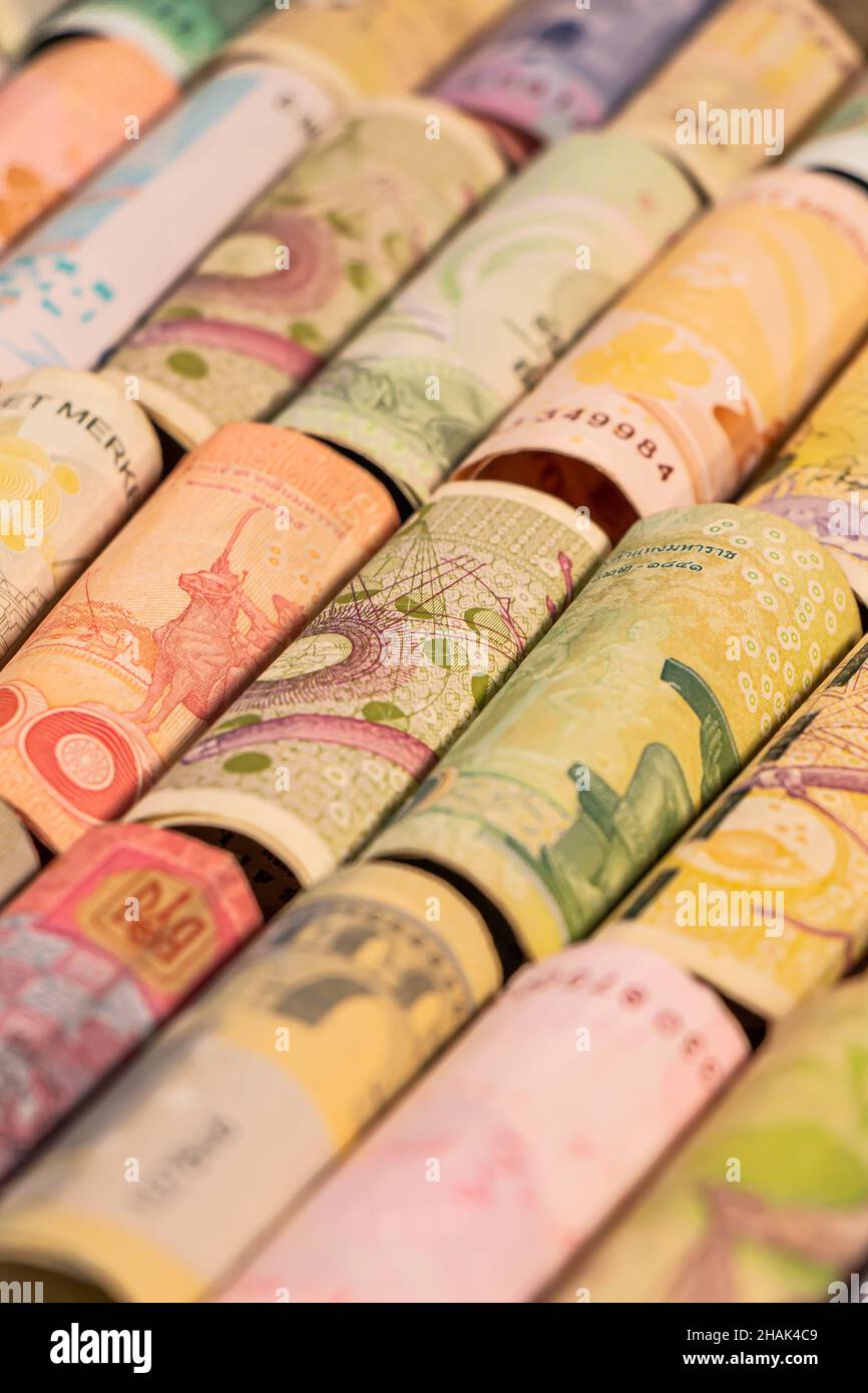 Different colourful banknotes from various countries on rolls to be used for illustrating subjects as business, banking, media etc. Stock Photo