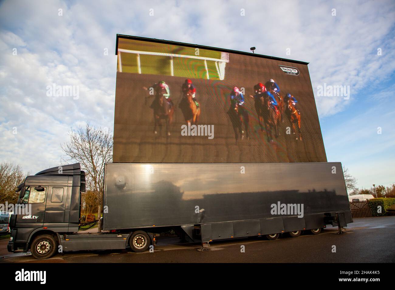 Outside broadcast of horse racing being shown on a large mobile screen at  Warwick racecourse England Stock Photo