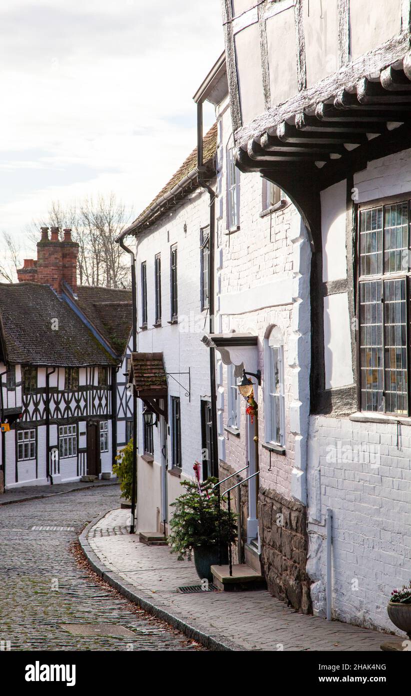 Half timbered black and white cottages along the cobbled Mill Street in ...