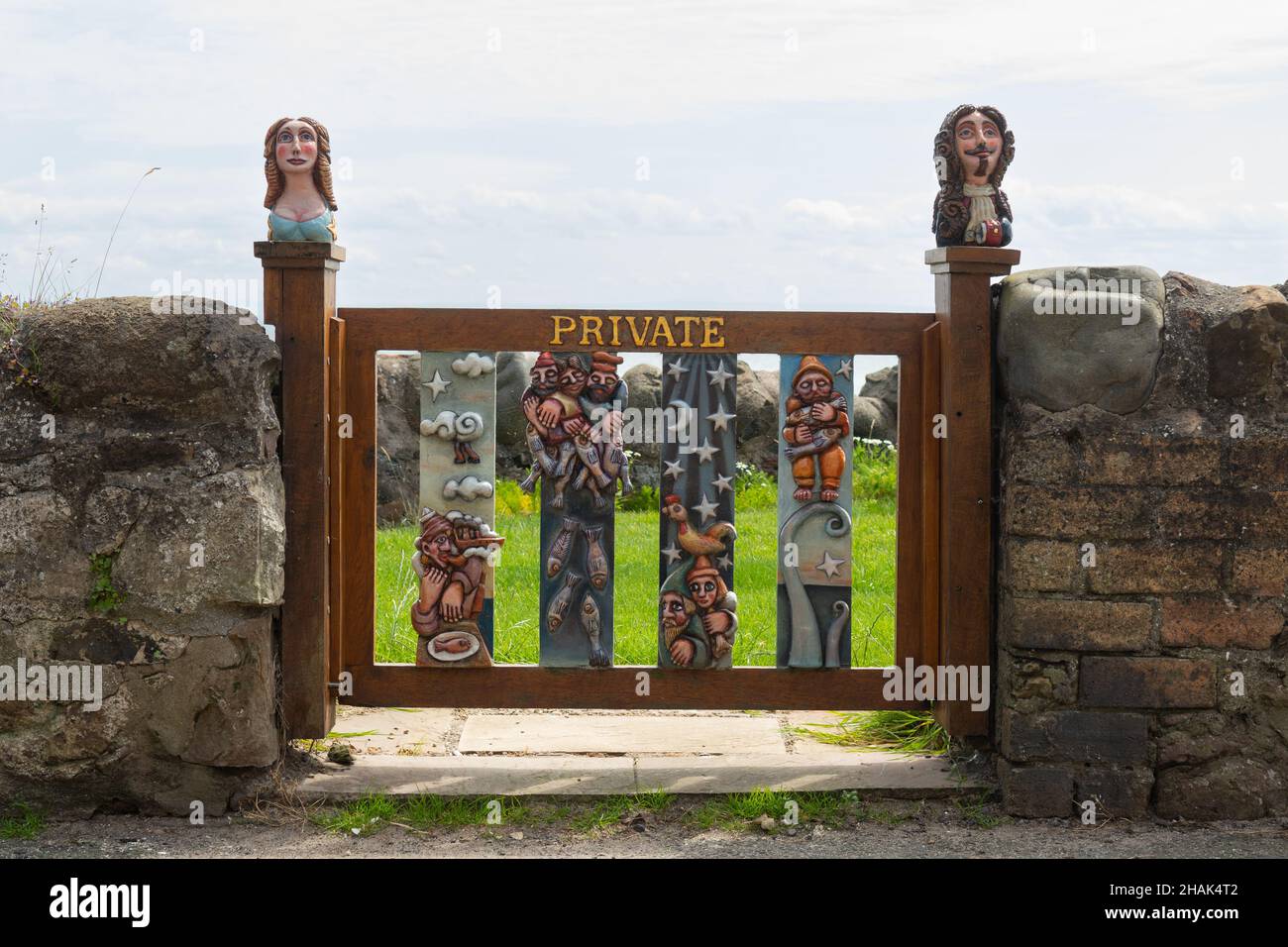 unusual carved and painted wooden garden gate, carved by Alan Faulds, Lower Largo, Fife, Scotland, UK Stock Photo