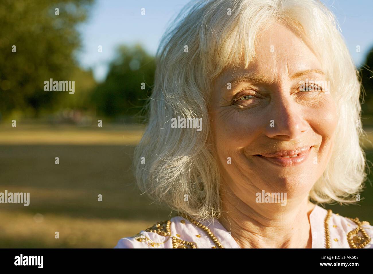 Portrait of senior woman with grey hair smiling. Stock Photo