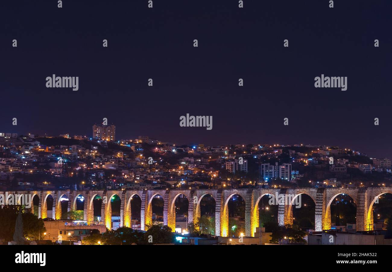 The viaduct of Queretaro city and its skyline at night, Mexico. Stock Photo