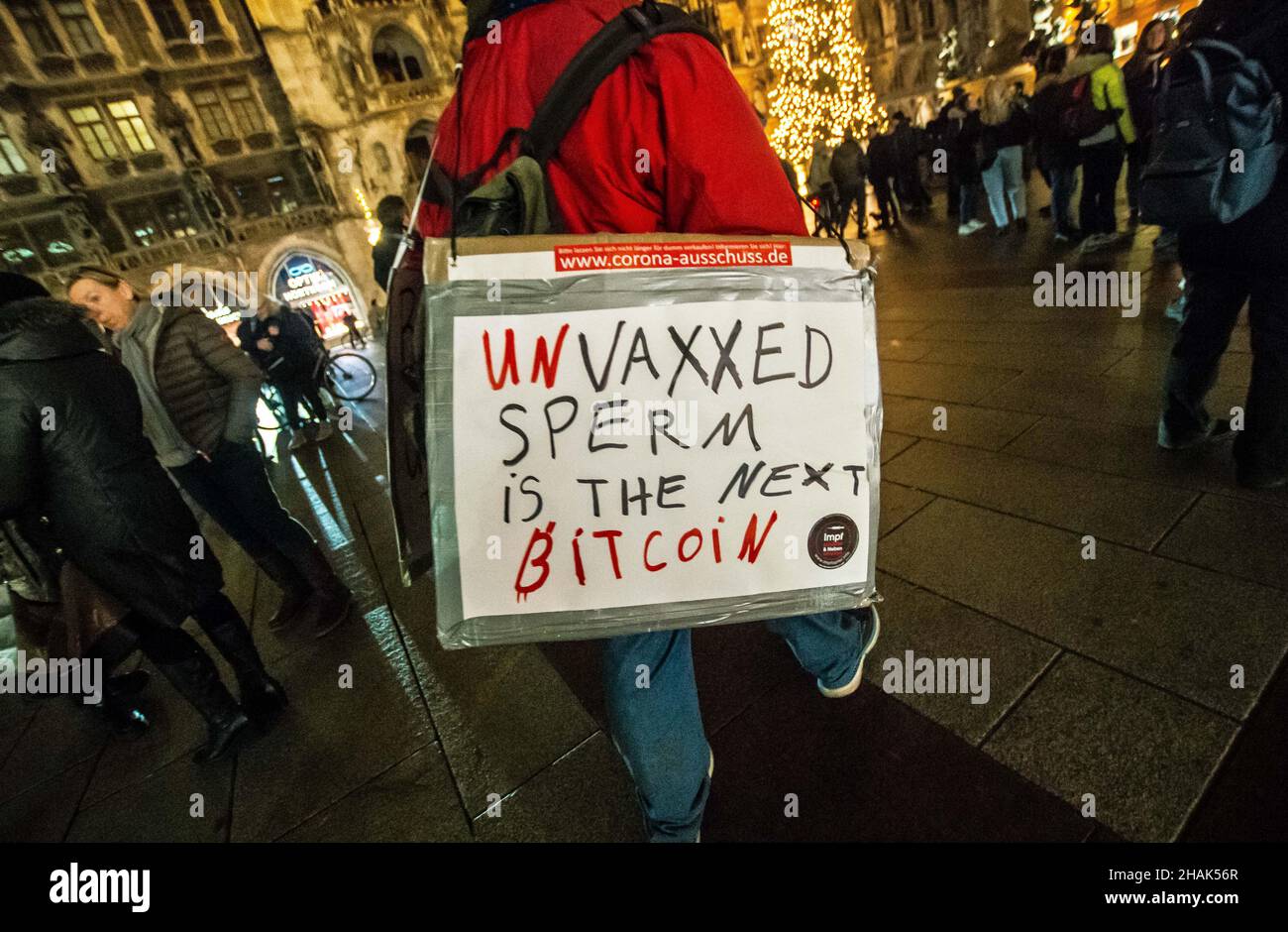 Munich, Bavaria, Germany. 13th Dec, 2021. An example of one of the signs at an anti-vaxx, anti-infection control demo in Munich, Germany where a demonstrator somehow equates the sperm of the unvaccinated as the next big cryptocurrency. As part of an increasing frequency of unregistered demos, 140 Corona deniers of Munich, Germany assembled again at Marienplatz and walked alongside flag-holding SHAEF Reichsbuerger (sovereign citizens) towards Stachus and back. Police assembled lines to keep the participants in a certain area, at which point some argued and eventually left the area. The gr Stock Photo
