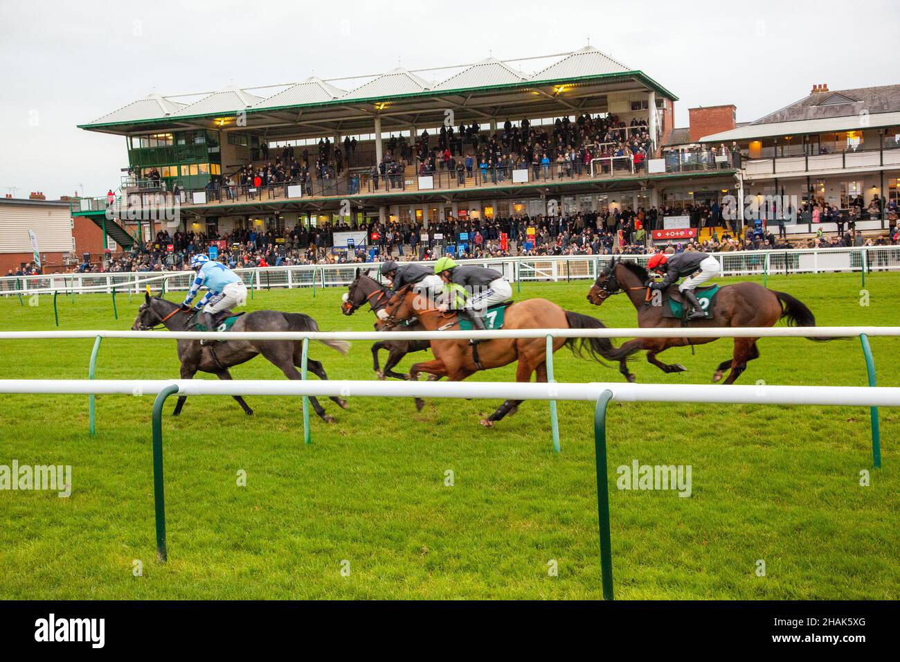 National hunt horse racing at Warwick racecourse England with action in front of the main stand taken from the  caravan and motor home club site 2021 Stock Photo