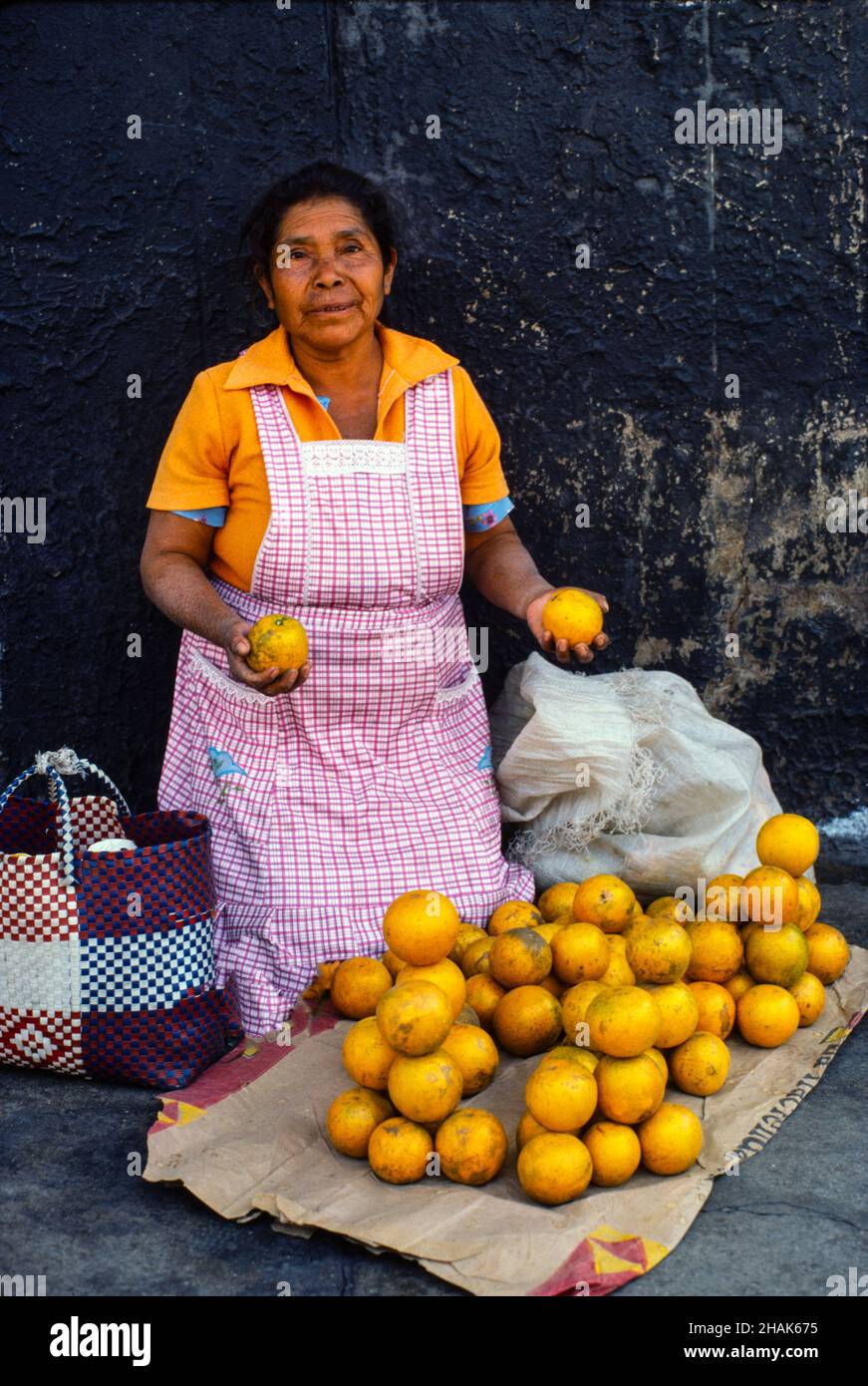 woman selling oranges on a street in Oaxaca Mexico Stock Photo