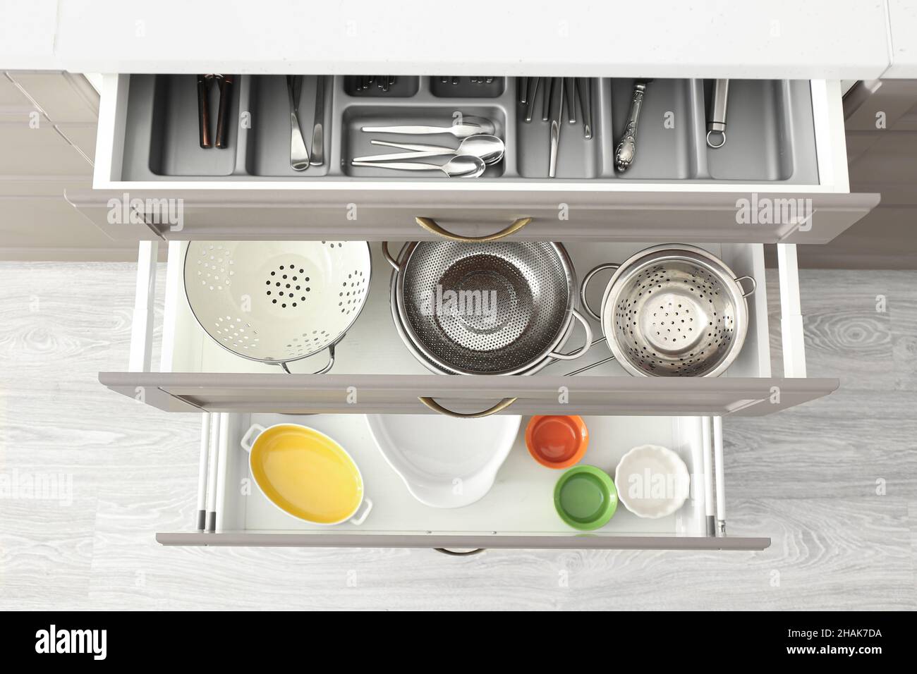 Set of kitchenware in open drawers Stock Photo - Alamy