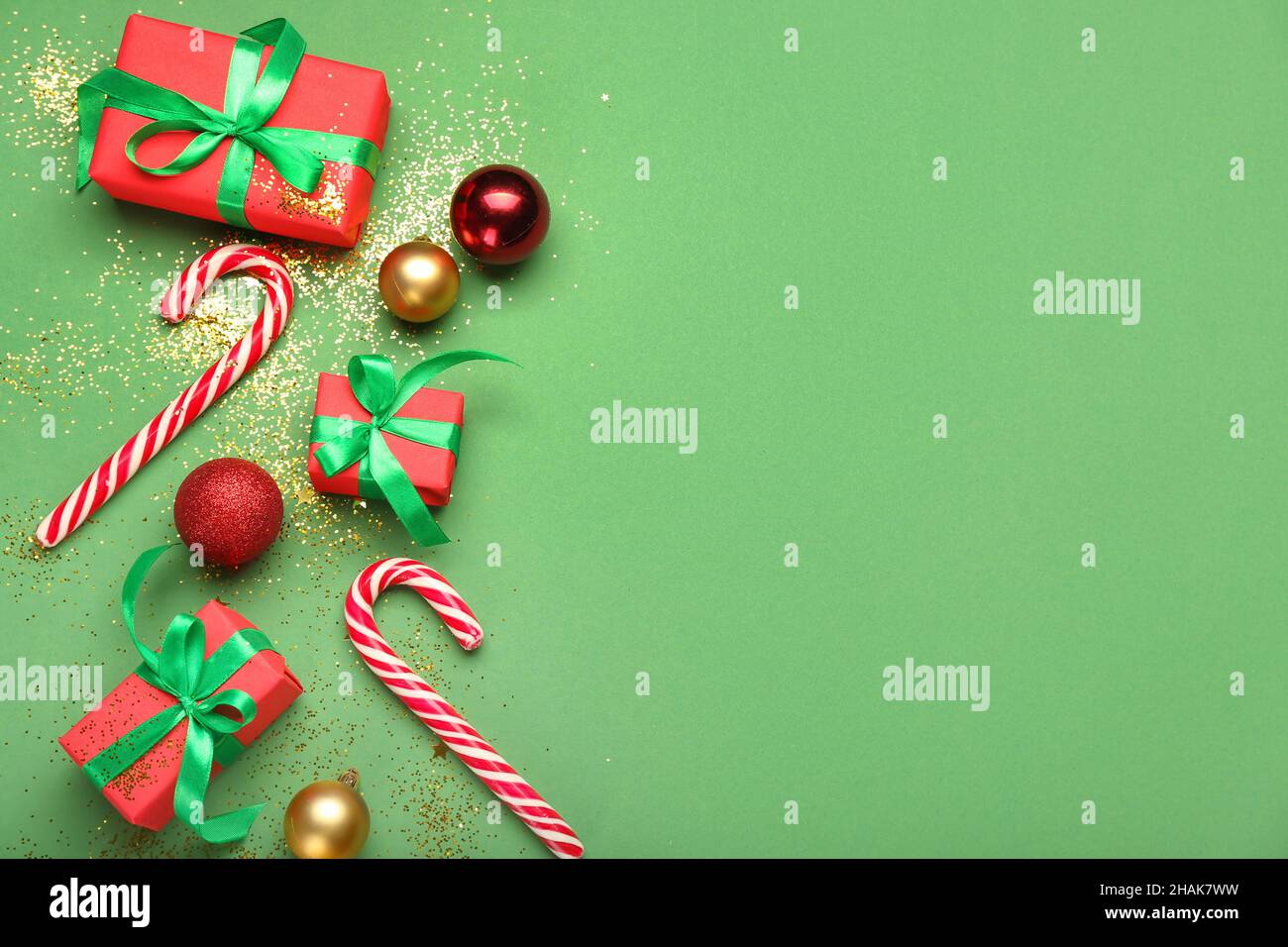 Christmas decor and gift boxes on green background Stock Photo - Alamy