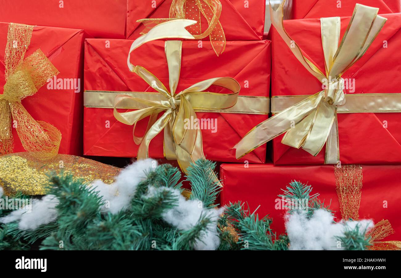 Christmas gift boxes with decorations. Red boxes with gifts tied golden