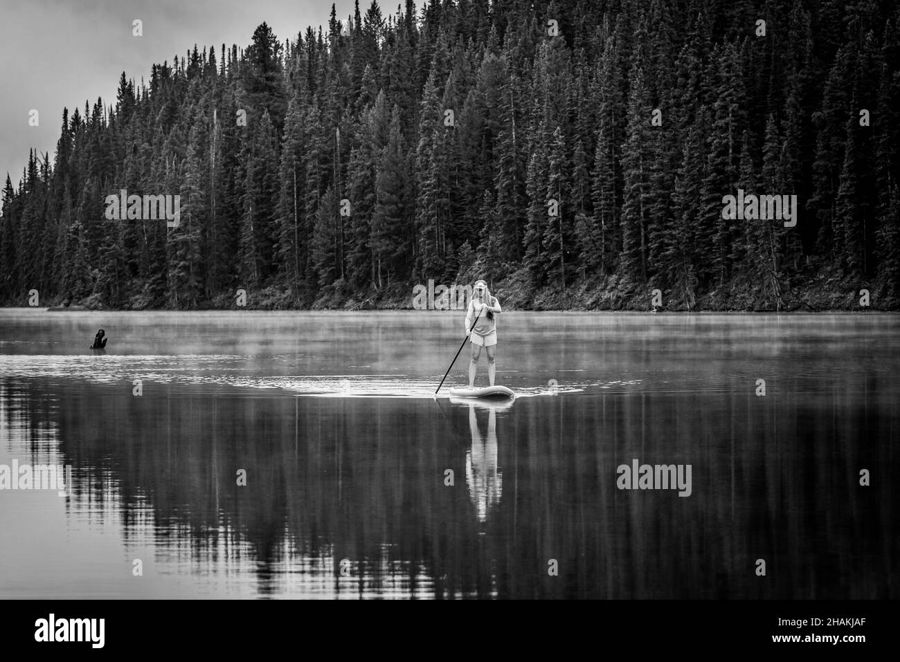 7/14/21 - Crested Butte, Colorado - A woman demonstrates how to do handstands and yoga on an paddle board. Stock Photo