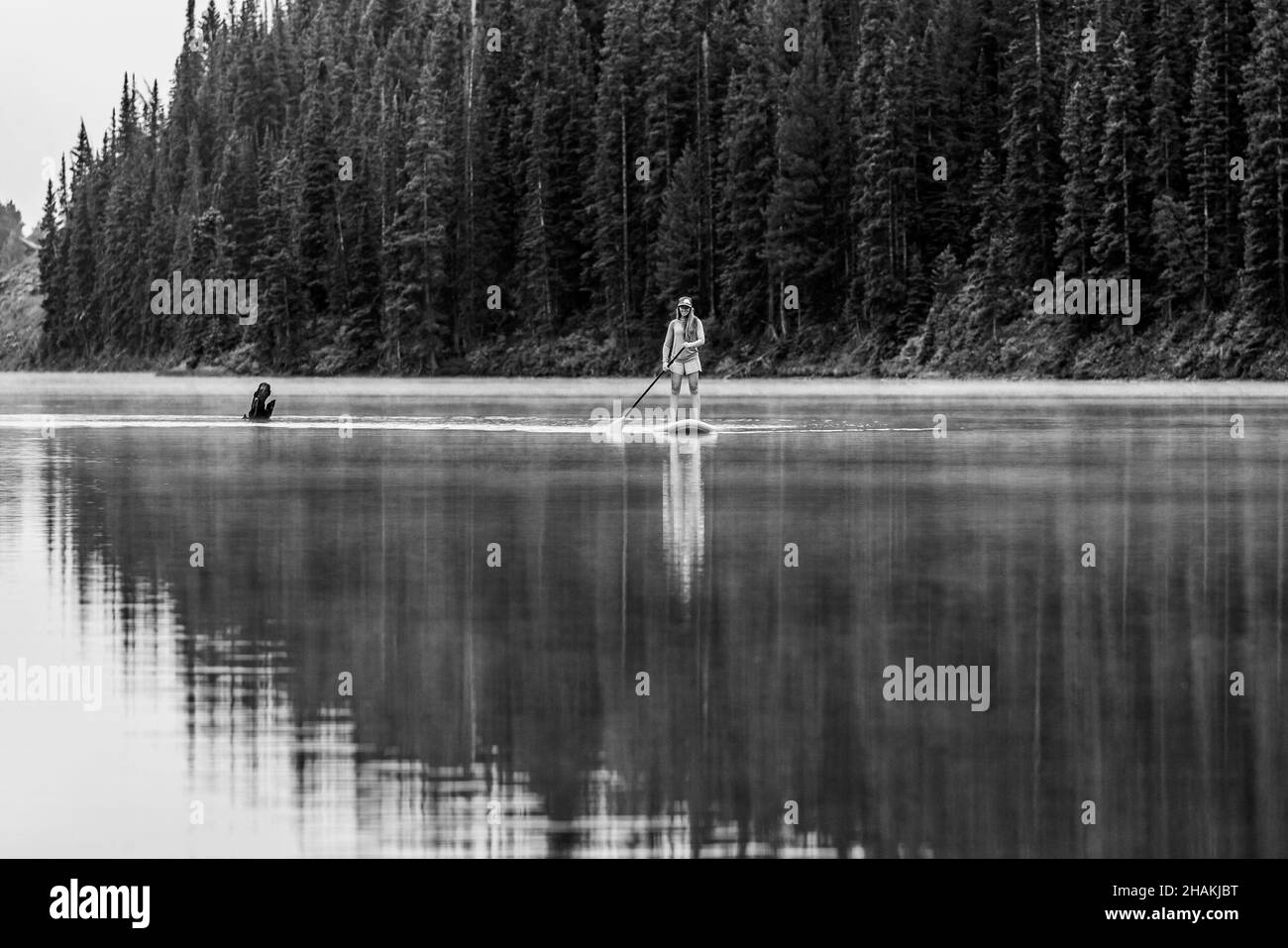7/14/21 - Crested Butte, Colorado - A woman demonstrates how to do handstands and yoga on an paddle board. Stock Photo