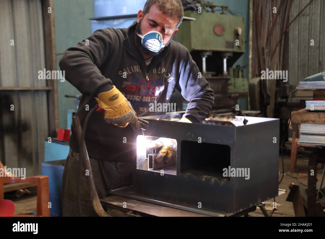 Beirut, Lebanon. 10th Dec, 2021. A worker makes a heater in a factory