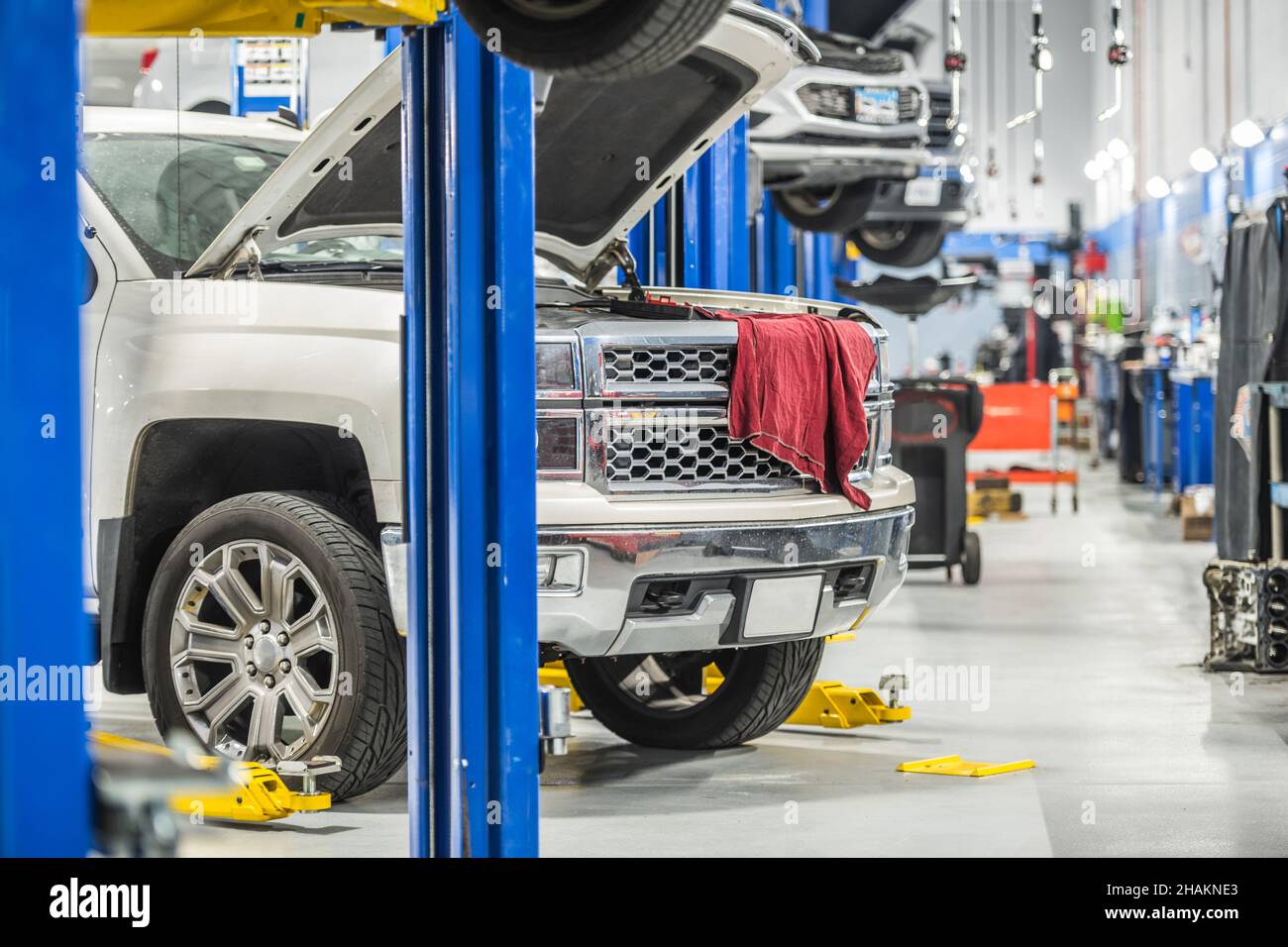 Car Dealership Auto Service Area. Clients Vehicles on Automotive Lifts