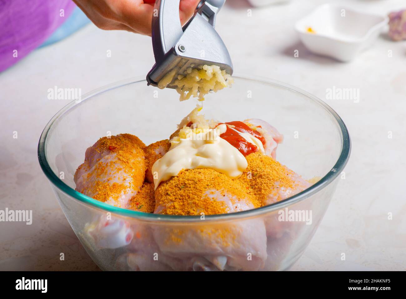 chicken drumsticks in a cup add garlic Stock Photo