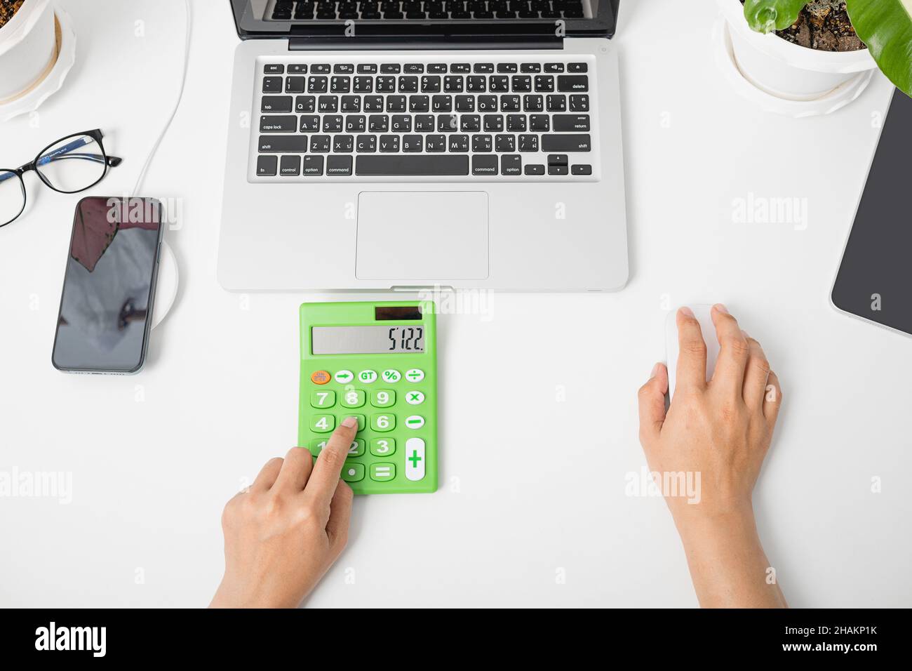 Accountant working and analyzing financial calculating with calculator and  laptop computer income-expenditure at office desktop, Business financial an  Stock Photo - Alamy