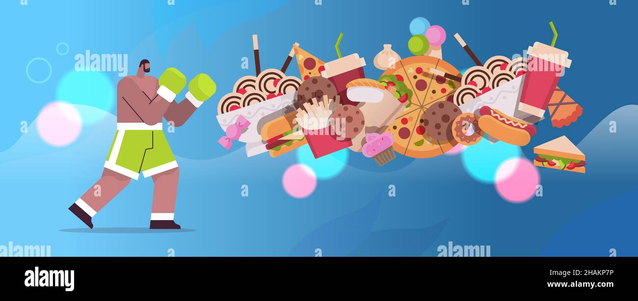 man boxer hitting junk food assortment of fast food unhealthy nutrition