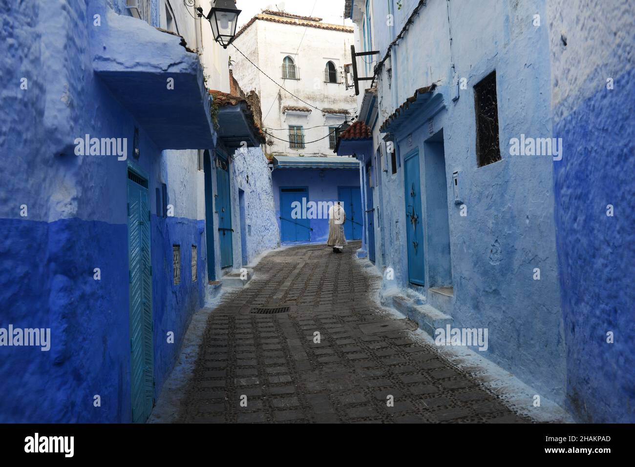 A local man walking through the narrow streets of the medina of Chefchaouen, Morocco. Stock Photo