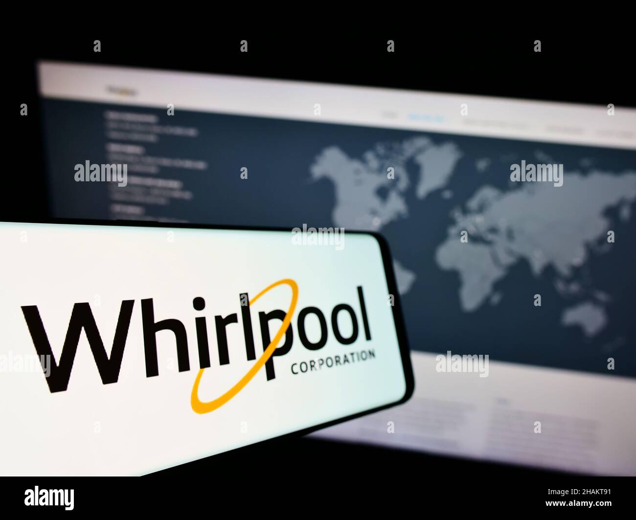 Smartphone with logo of US home appliances company Whirlpool Corporation on screen in front of business website. Focus on left of phone display. Stock Photo