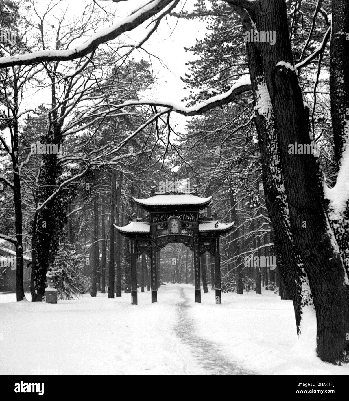 Paris Jardin d'Agronomie Tropicale Chinese Gate in snow during World War II. The photograph captures the gate (which was built out of redwood for a 1906 exhibition) in deep snow with a path going through it. The location is on the edge of the Bois de Vincennes. The photo was made in early 1945.  Photographer Clarence Inman was stationed nearby in Nogent-sur-Marne where he directed the processing lab for the Paris field office of the Field Photo Branch of the United States Office of Strategic Services (OSS). Stock Photo