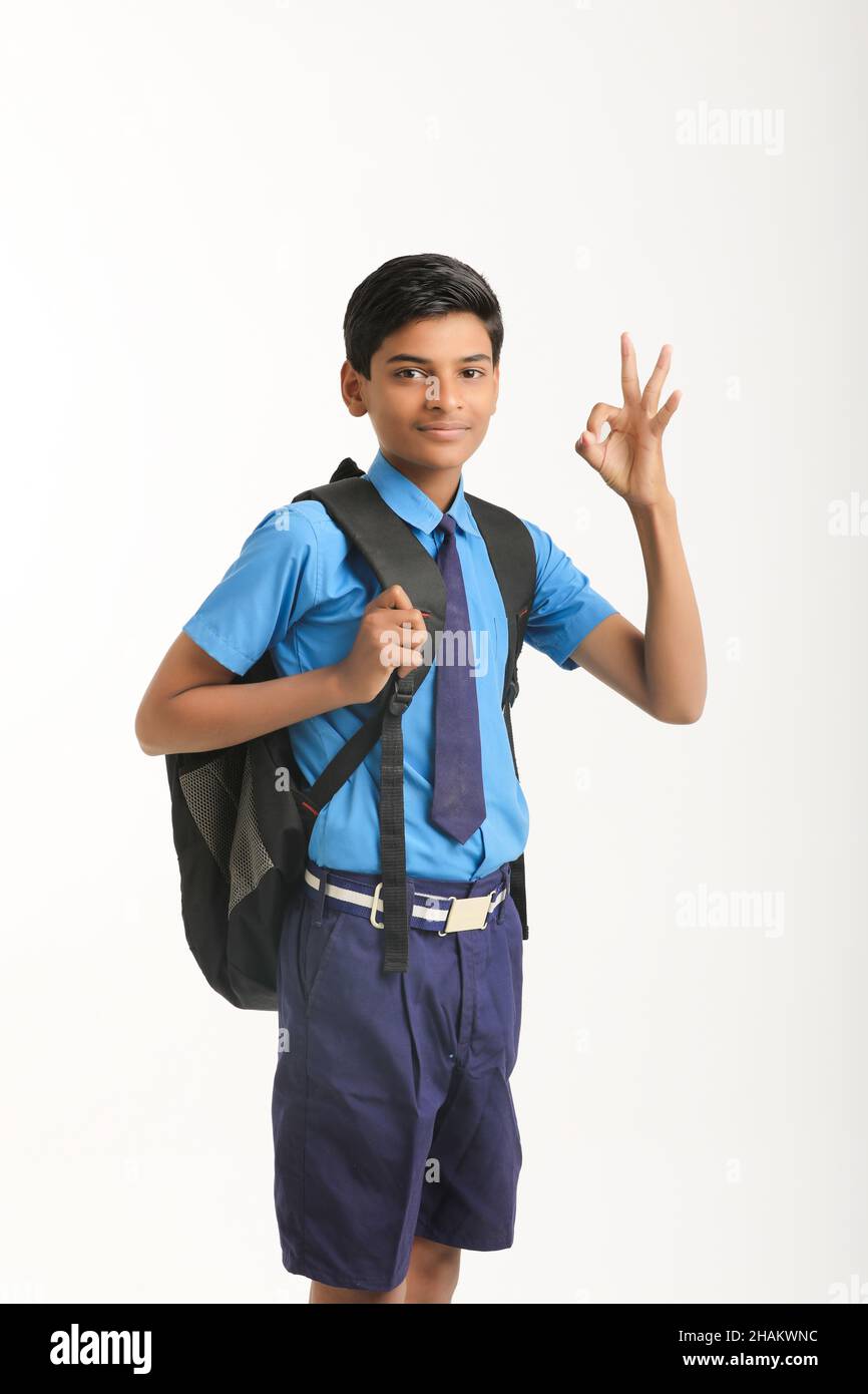 Indian school boy standing on white background. Stock Photo