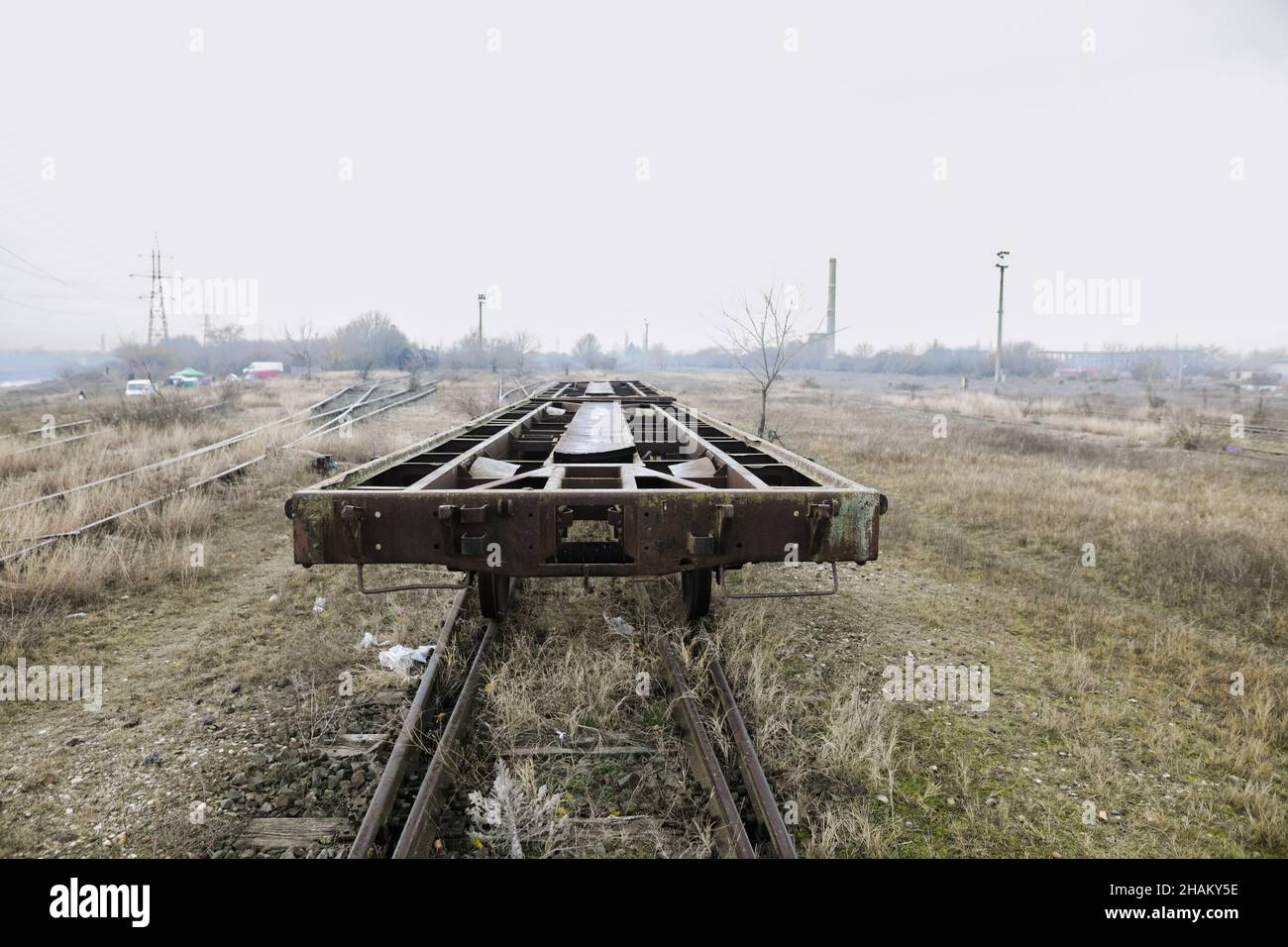 Shallow depth of field (selective focus) image with old and rusty railway industrial transportation waggon (dresine). Stock Photo